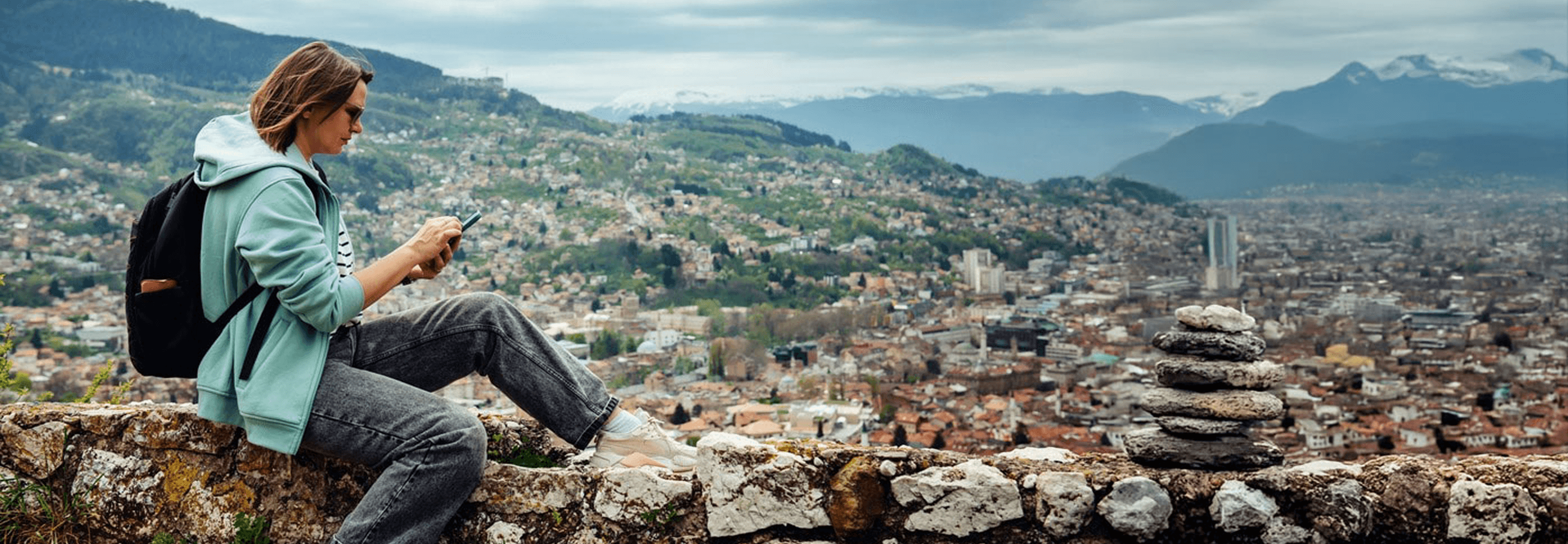 Traveler on a mountainside using a phone